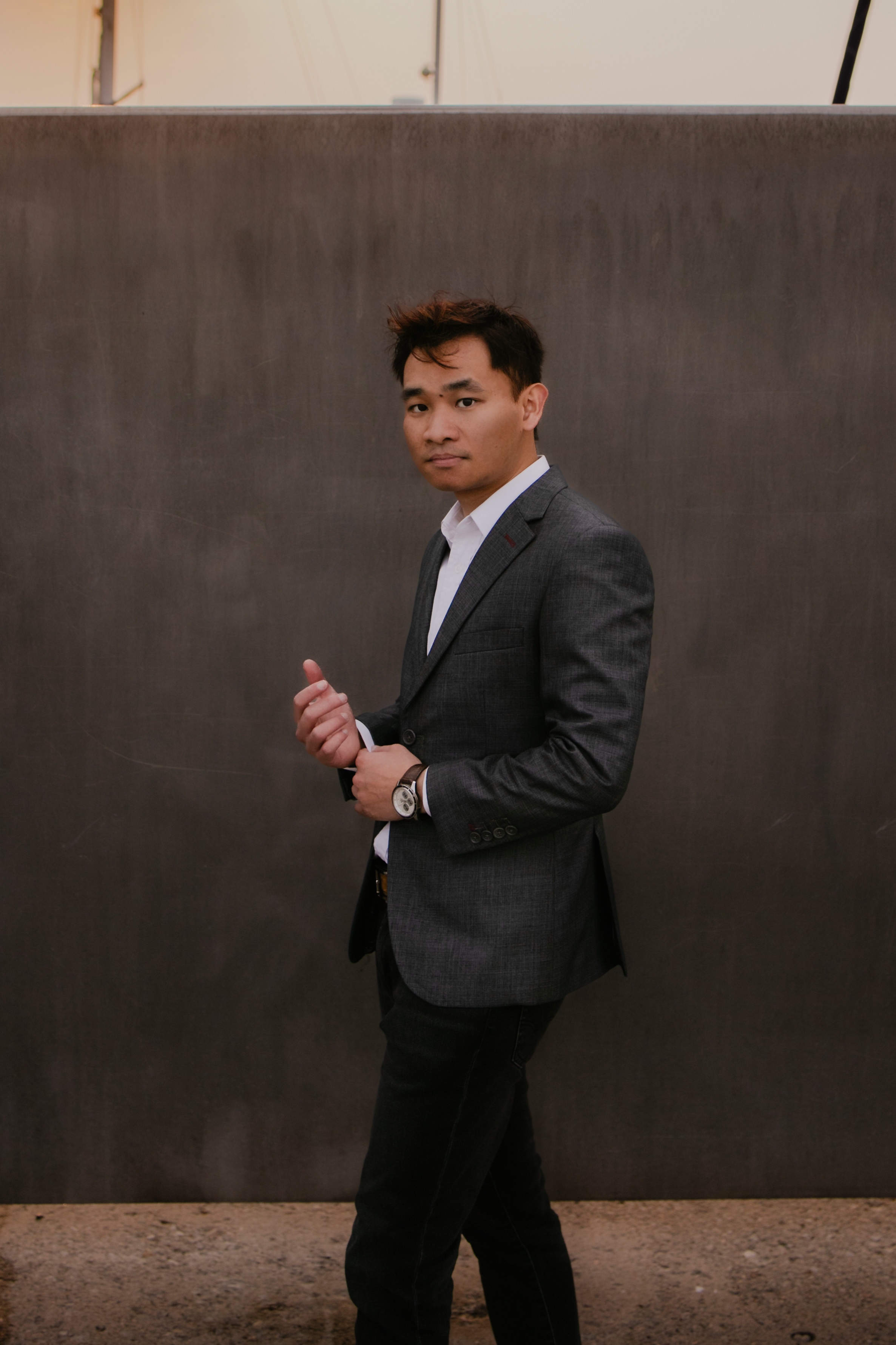 Thomas Chung smiling in a red plaid shirt and tortoise shell glasses